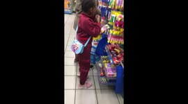 Little girl pretends to eat snack beside mom in Kariega, South Africa