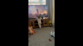 Toddler's confused reaction after getting caught touching the TV is PURE COMEDY!