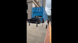 Pedestrian flees as scaffolding collapses onto pavement in China