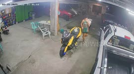 Schoolboy tries to clean motorcycle only for it to topple over