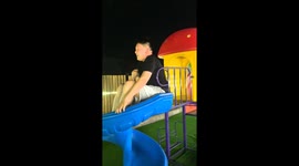 Man gets stuck on kid's garden slide making it topple over