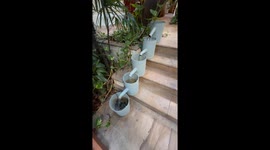 Cool water feature made from watering cans on steps