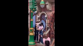 Disneyland visitors fight in the queue for photo booth