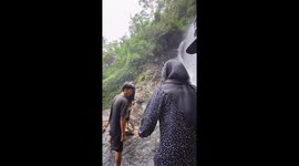 Husband slips down waterfall while admiring nature with family