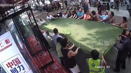 Residents hold mat to catch 102-year-old woman falling from building