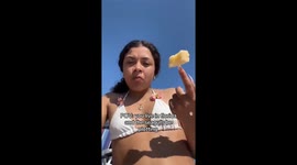 Beach day turns sour when seagull hilariously snatches snack off of girl's nail