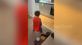 Adorable moment tot captured practicing superman pose