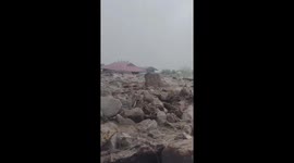 Flash floods carrying huge rocks and mud buried many houses in central Vietnam