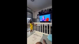 Toddler dances and freezes with performer on TV in Cainta, Rizal, Philippines