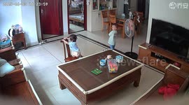 Young girl climbs onto chair, quick-thinking older brother moves it beside coffee table