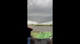 Tornado forms in distance amid heavy rain in Oklahoma, USA