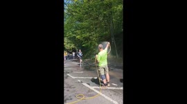 Man cools down Leeds Marathon runners with hose shower in West Yorkshire, England