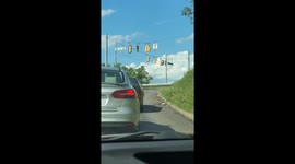 Red Car Carries Wide Load In Peculiar Way