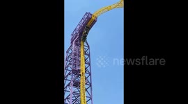 Thrill-seekers left hanging upside down after coin dropped by passenger brings roller coaster to a halt
