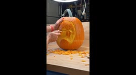 Pumpkin carver transforms a simple pumpkin into an expressive face sculpture