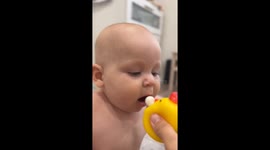 Baby plays with toy chicken in Krasnodar, Russia