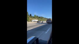 Truck carrying logs has a Final Destination movie promo poster