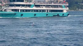 People take a refreshing dip in the fast currents of the Bosphorus in Istanbul