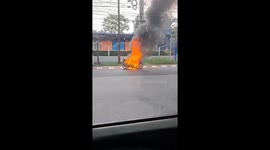 Motorcycle bursts into flames on the side of road