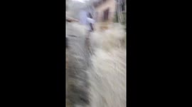 Floodwater surges through streets amid heavy rain in the Philippines