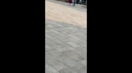Man showcases agility with parkour jumps and flip in Victoria Square, Birmingham, UK