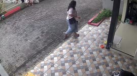 Woman loses balance and falls while taking off slippers in Surakarta, Indonesia
