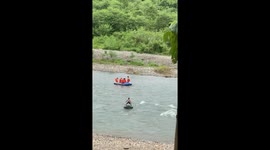 Little boy surfs on swim tube in river in Paya Bakong, North Aceh, Indonesia