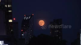 The June Full Moon known as the Strawberry Moon rises near the London Eye