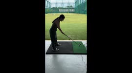 Golf beginner hits rubber tee instead of ball sending it flying down driving range