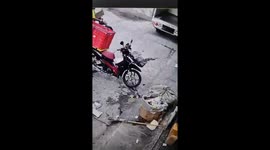 Delivery rider's motorcycle is so overloaded he topples over