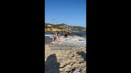 Man in wheelchair gets stuck in the tide on first-ever beach visit—Friend rushes to help