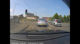 Impatient motorist doesn’t want to wait in traffic. Mounts pavement to bypass traffic at lights.