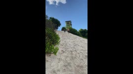 Little girl trips while chasing boy on the beach in Castanhal, Brazil