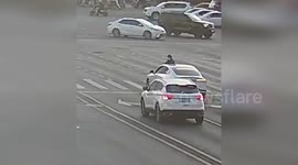 China: Motorcyclist Flies Over Car And Crashes Through Rear Windshield After Violent Collision