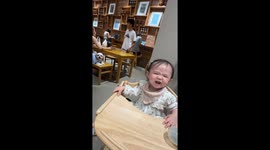 Toddler excited by puppy that appears in coffee shop