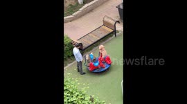 Adorable Pet Poodle Enjoys Carousel Ride with Elderly Companion in China