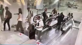Terrified airport passengers leap over deadly gap when escalator goes haywire