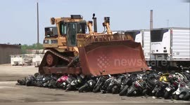 Police bulldozer crushes hundreds of illegal mopeds in New York