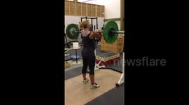 Pregnant woman doing some impressive weight lifting at the gym