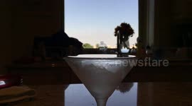 A glorious, slow-motion olive drop into a martini