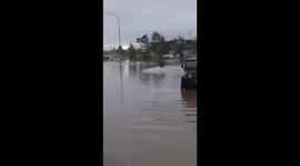Man takes jet ski out onto flooded street