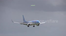Plane bounces as it lands on a windy day at Amsterdam Airport