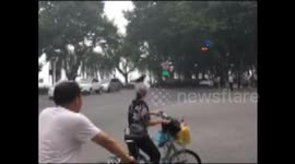Obedient bird stands on cyclist's head