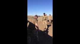 Soldier attempts to catch helmet on his head, fails