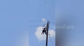 Young lady  climbed a nearby electric pole after a quarrel with her sister-in-law in Gaya, Northern India