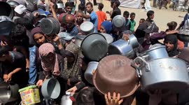 Displaced Palestinians receive hot meals in Gaza’s Khan Younis