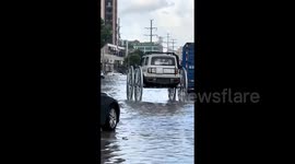 Modified Car Drives Through Floodwaters in Southern China, Later Towed by Police