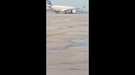 Smoke seen coming from plane engine parked at airport in India