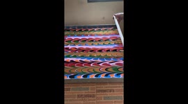 Artist demonstrates water surface marbling art technique