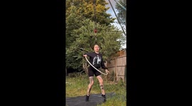 Woman Hanging on Her Hair and Hula Hooping